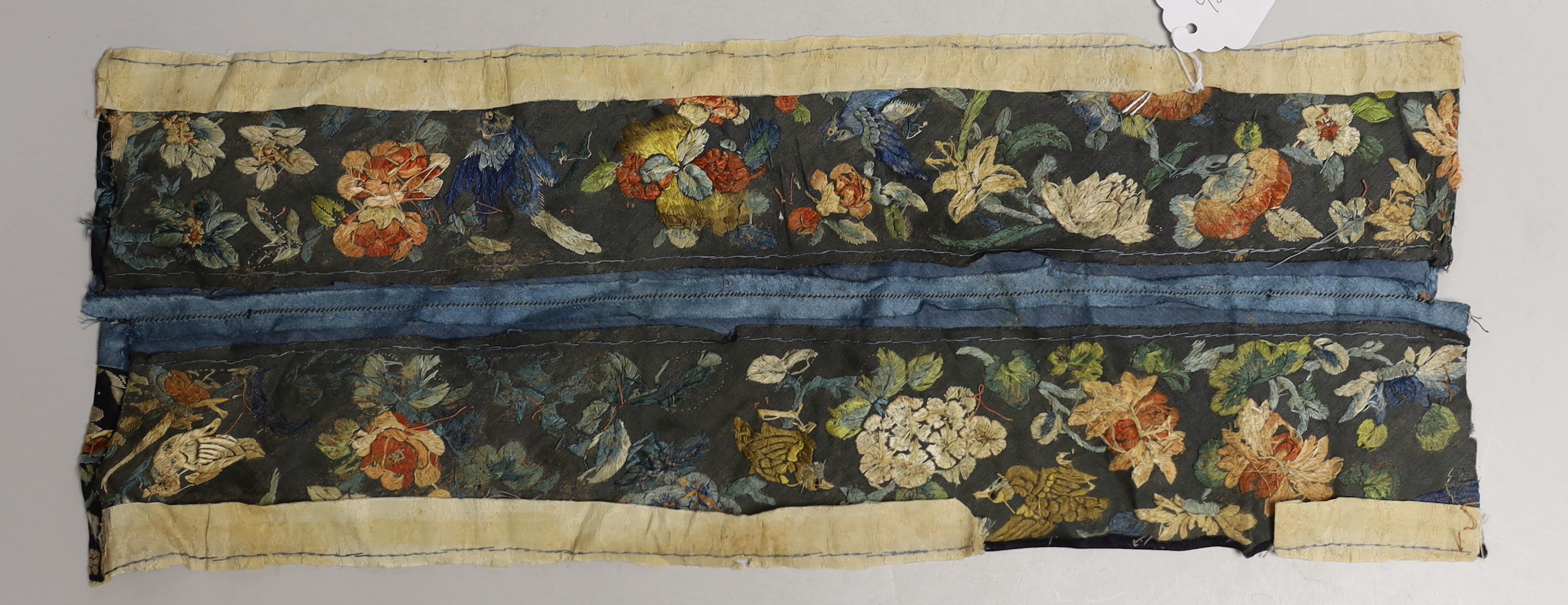 A Chinese embroidered silk sleeve panel